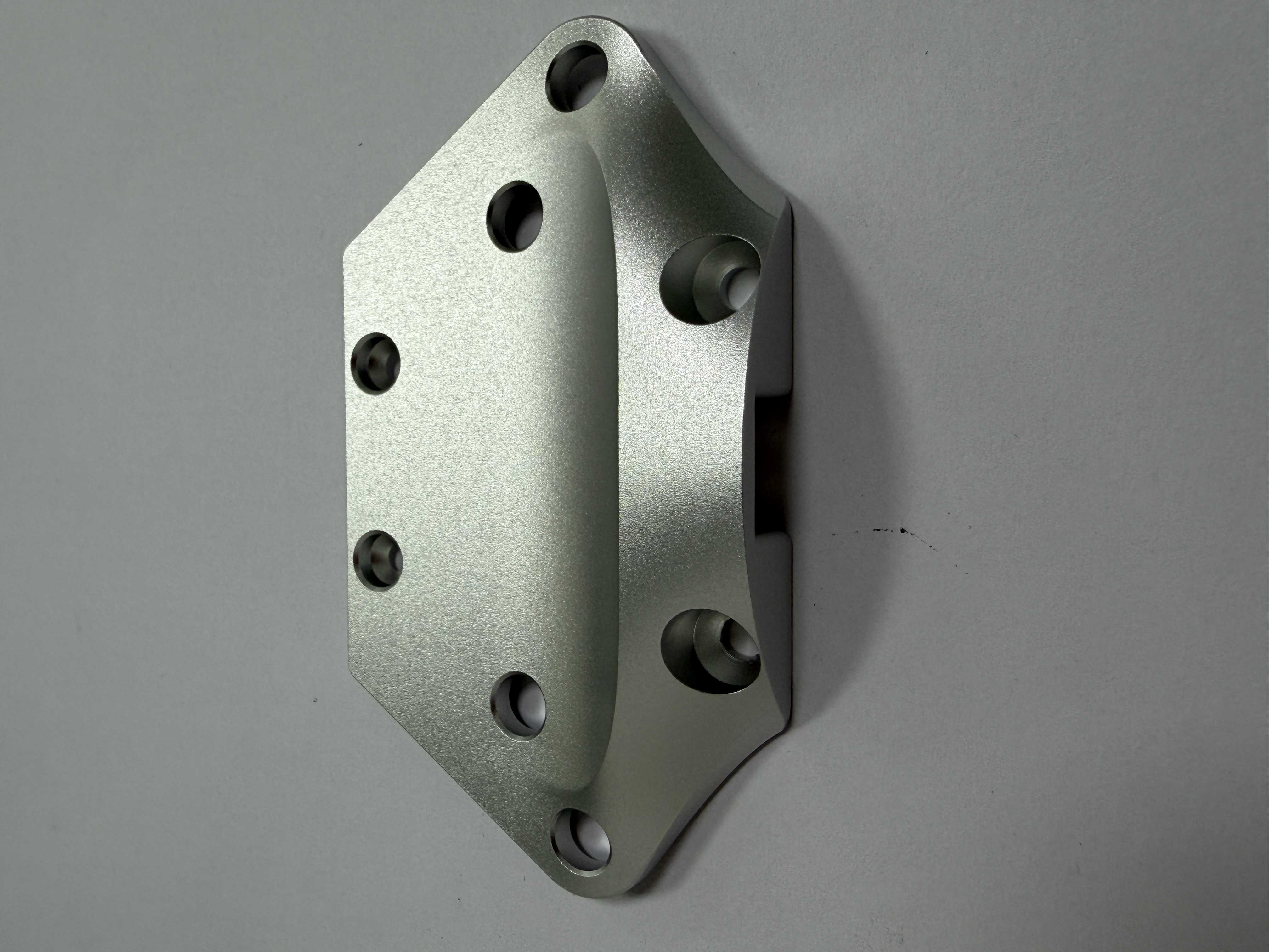 Machined metal plate with countersunk holes